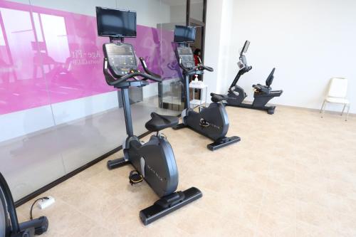 a row of exercise bikes in a fitness room at Hotel Kanade Kanku Kaizuka in Kaizuka