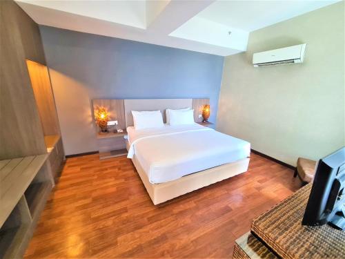 Ένα ή περισσότερα κρεβάτια σε δωμάτιο στο Nexus Regency Suites & Hotel
