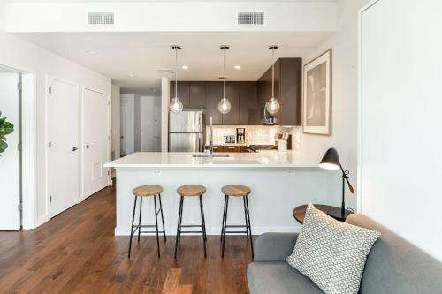 a kitchen with a bar and two stools at Kislak 601 1BR Penthouse with Stunning Rooftop Terrace in Newark