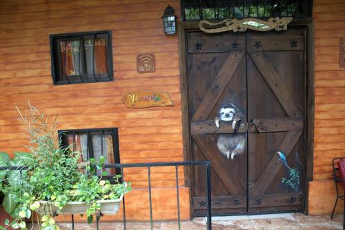 a dog sitting in the door of a house at Salamandra Costa Rica in Jiménez