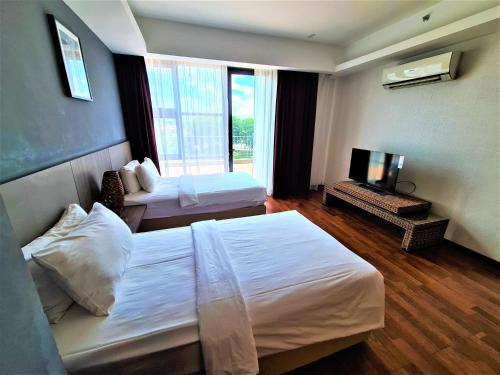 Ένα ή περισσότερα κρεβάτια σε δωμάτιο στο Nexus Business Suite Hotel