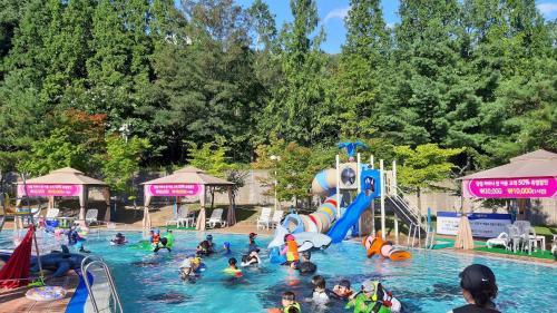 a group of people in a swimming pool at a water park at The K Hotel Gyeongju in Gyeongju