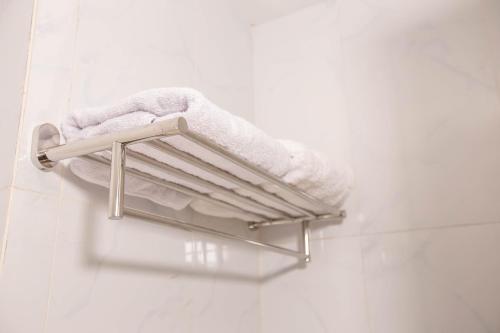 a towel rack on the wall of a bathroom at Urban Express HomTel - Serpong in Banten