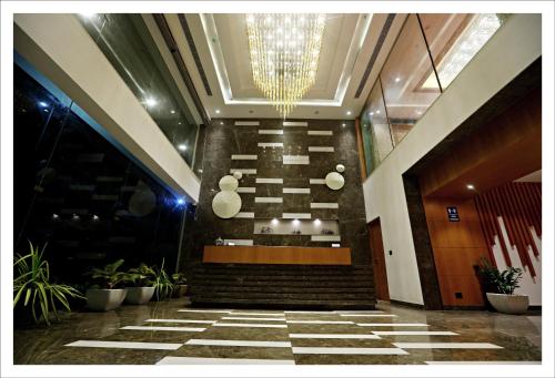 a lobby with a staircase in a building with plants at Best Western Plus Tejvivaan in Visakhapatnam
