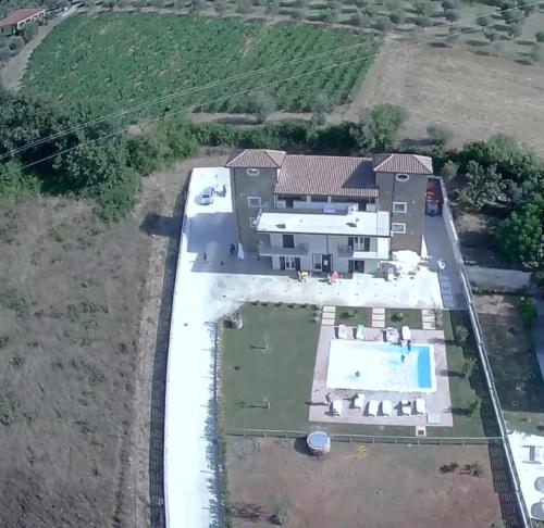 an aerial view of a house with a swimming pool at LE TORRI DEL CILENTO in Santa Maria di Castellabate