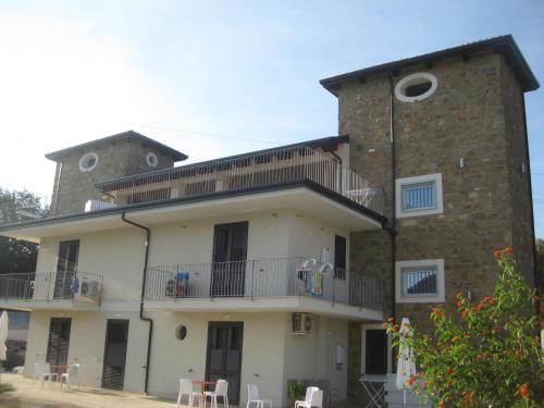 a large brick building with a balcony on top at LE TORRI DEL CILENTO in Santa Maria di Castellabate