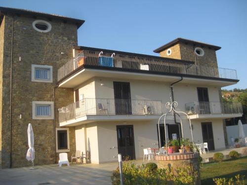 a large building with a balcony on top of it at LE TORRI DEL CILENTO in Santa Maria di Castellabate