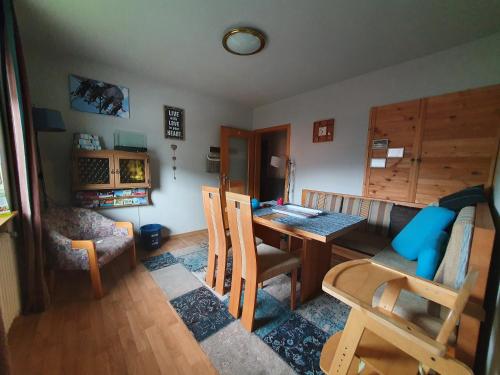 a living room with a table and chairs and a couch at fun4all-holidayhome in Medebach