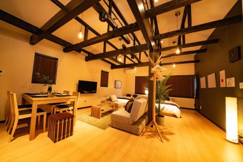 a living room with a table and a couch and a desk at EAST ONE Higashishinjuku in Tokyo