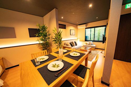 a dining room and living room with a table and chairs at EAST ONE Higashishinjuku in Tokyo