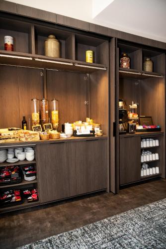 a kitchen with a counter with food on it at Best Western Plus Hôtel Colbert in Châteauroux