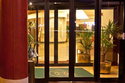 a view of a store front door with plants outside at Hotel Mirage Sure Hotel Collection by Best Western in Milan