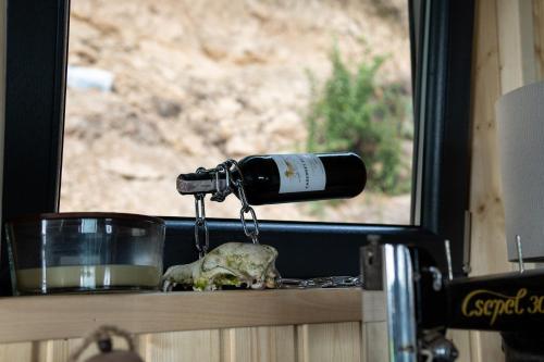 a bottle of wine on a counter with a skull at Houses with a View#Sauna#Jaccuzi in Gozdowice
