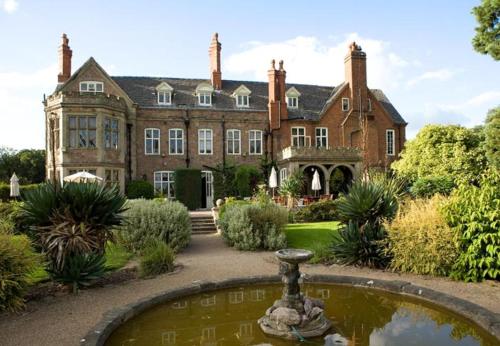 an estate with a fountain in front of a building at Rothley Court Hotel by Greene King Inns in Rothley