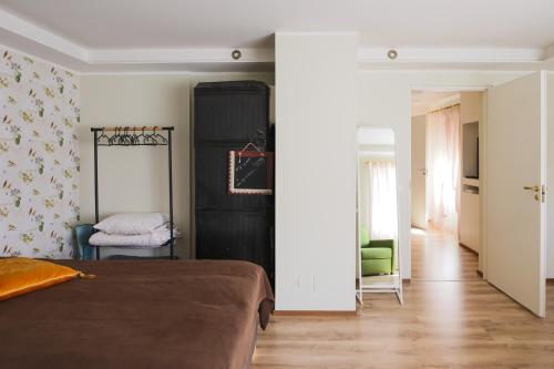 a bedroom with a bed and a hallway at Lapmanni Holiday Home in Haapsalu