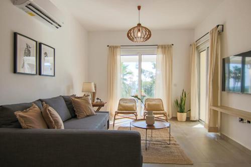 a living room with a couch and a table at Phaedrus Living Seaview Luxury Flat Limnaria 153 in Paphos City