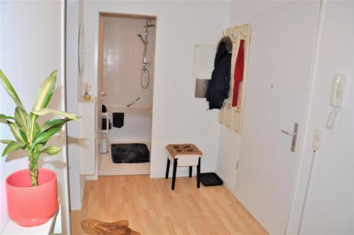 a bathroom with a shower and a potted plant at GardenOasisBerlinAirport in Schönefeld