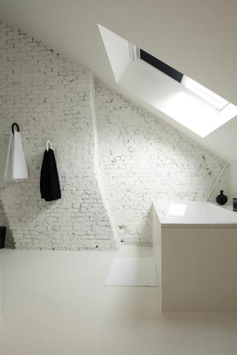 a white room with a white brick wall at Maison Nationale City Flats & Suites in Antwerp