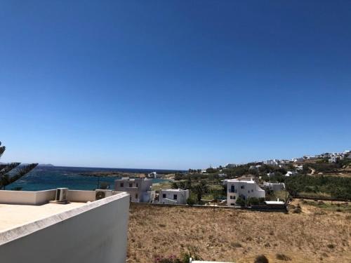 a view of a group of houses and the ocean at Akrogiali Hotel in Agios Sostis
