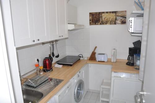 a kitchen with a sink and a washing machine at GardenOasisBerlinAirport in Schönefeld