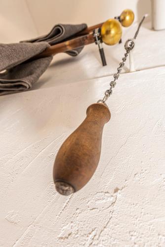 a wooden spoon hanging on a chain on a table at Louse Puschen Manufaktur in Kiel