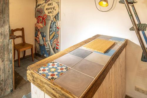 a wooden table with a tiled floor in a room at Louse Puschen Manufaktur in Kiel