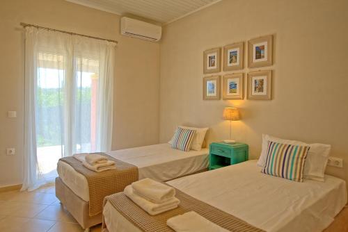 A bed or beds in a room at Beach Villa Joanna by PosarelliVillas