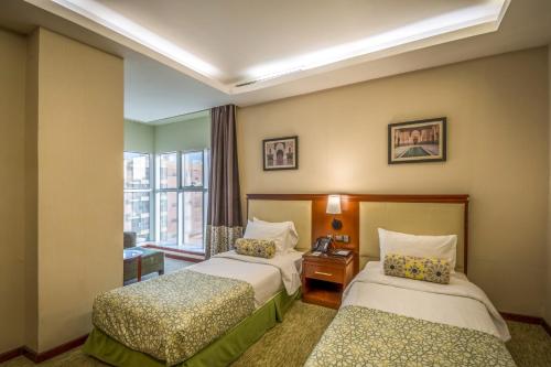 Säng eller sängar i ett rum på Grand Plaza Hotel - Dhabab Riyadh