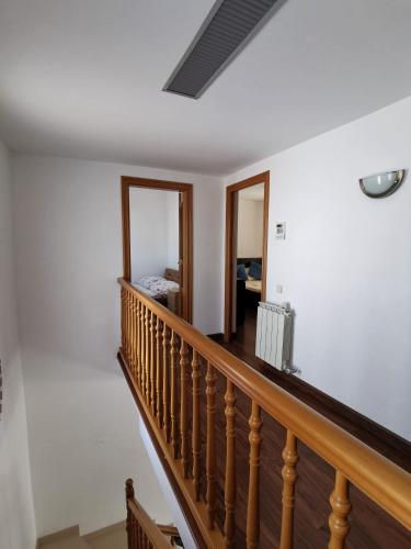 a staircase in a home with white walls and wooden railings at Villa Arcos in Segur de Calafell