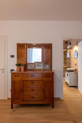 a wooden dresser in a kitchen with a window at Il Treno dei Sogni - Bed & Relais in Conselve