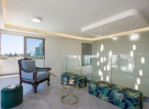 a living room with a chair and two couches at Incognito Creta Luxury Suites and More in Kolymvari