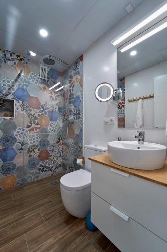 a bathroom with a sink and a toilet and a shower at El Coso Boutique Lucena in Lucena