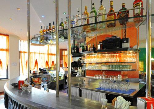 a bar with a lot of glasses on a counter at Hotel Centro Turistico Gardesano in Bussolengo