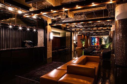 a living room with a couch and a bar at THE STEEL HOUSE in Kitakyushu