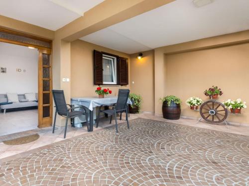 a living room with a table and chairs and a rug at Apartment Beni-1 by Interhome in Matulji