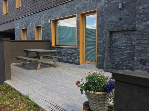 a wooden deck with a picnic table next to a building at Holiday Home Levi hillside by Interhome in Levi