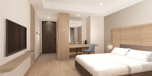 a bedroom with a bed and a desk and a television at The Grand Sumorum in Seogwipo