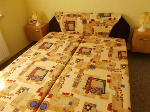 a bedroom with a bed with a colorful bedspread at Ferienwohnung Lohse in Kurort Altenberg