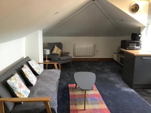 a living room with a couch and a table at Merriland in Broadstairs