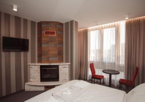 a hotel room with a bed and a fireplace at Hotel Chicago in Shkodër