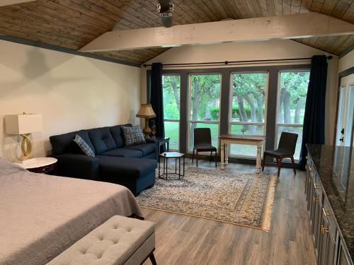 a bedroom with a blue couch and a living room at Salado Cottage Retreat near Downtown in Salado
