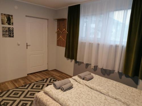 a bedroom with two beds and a window at Sombor 19 Central Apartment in Sombor