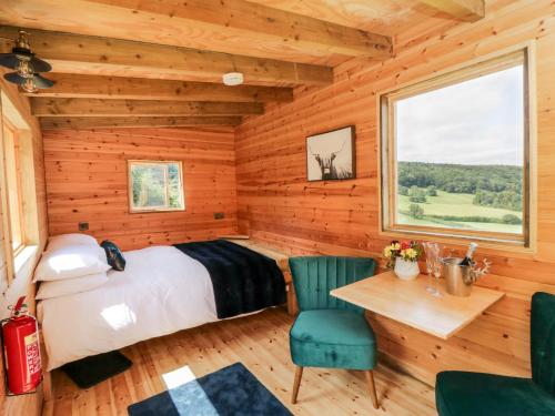 - une chambre avec un lit, une table et des chaises dans l'établissement Shepherd's Hut, à Scarborough