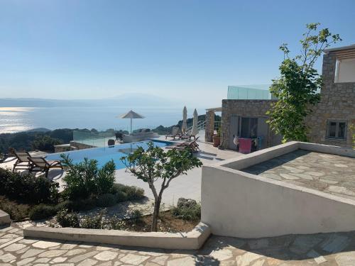 a villa with a swimming pool and a view of the ocean at Villa Salina Luxury Pool Villa in Kechria