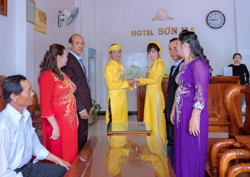 Un grupo de personas de pie en una habitación en Khách Sạn Sơn Hạ, en Kon Tum