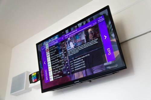 a flat screen tv hanging on a wall at Ubytovňa Milex in Nové Mesto nad Váhom