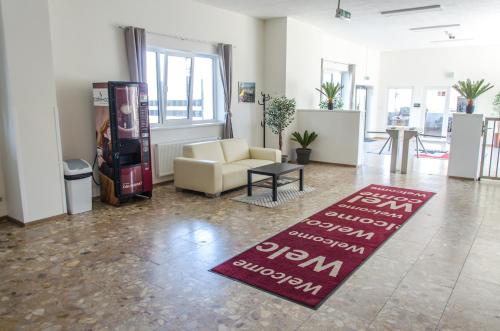 a living room with a couch and a rug on the floor at Ubytovňa Milex in Nové Mesto nad Váhom