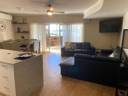 a living room filled with furniture and a tv at The Esplanade Riverview Holiday Apartments in Maroochydore