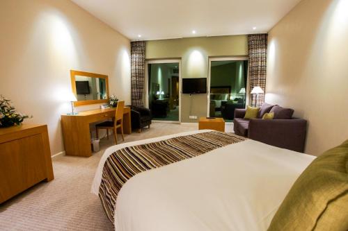 a hotel room with a bed and a living room at Hotel de France in Saint Helier Jersey