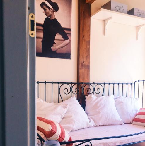a bedroom with a bed with a poster on the wall at Una casa in Val di Chiana - Tuscan Country House Cetona in Cetona